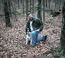 man with dog in woods