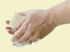 woman washing hands with herbaria all natural soap